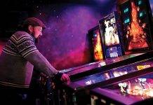 arcade gamer looking at the machine