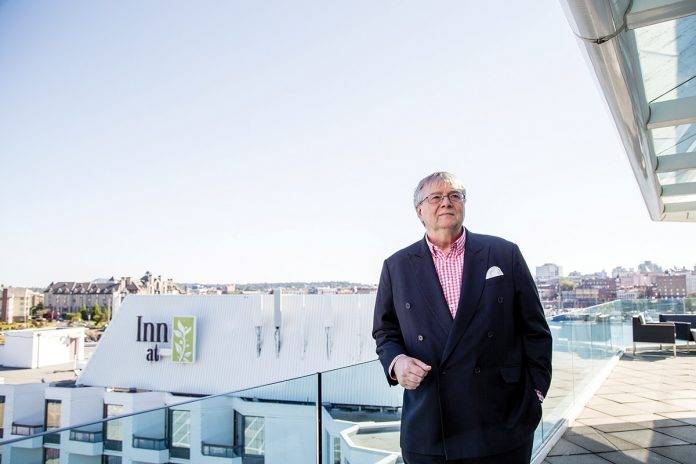 Ian Powell on the rooftop deck of the Inn at Laurel Point. Photo by Belle White.