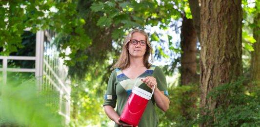 Civil engineering researcher Heather Buckley holds a container of wastewater samples on the way to the UVic lab for analysis, part of a project collecting, managing and reporting data from wastewater plants.