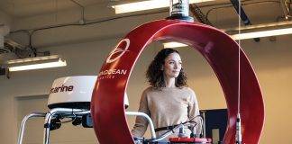 Julie Angus, CEO of Open Ocean Robotics, with one of their unmanned vessels.