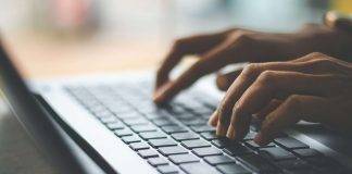 person typing on keyboard