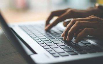 person typing on keyboard