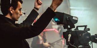 Behind the scene. Multiple camera setup. Cameraman shooting the film scene with camera in film studio. Group cinema set
