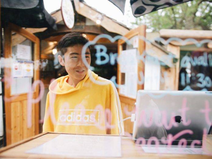 photo of man looking into window of eatery on salt spring island