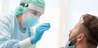 Photo of nurse administering a COVID-19 test