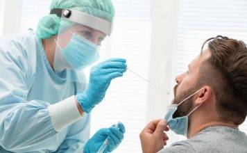 Photo of nurse administering a COVID-19 test