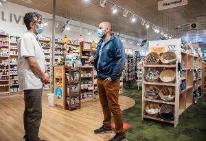 Rasool Rayani chats with a member of staff at Heart Pharmacy in Victoria, BC.