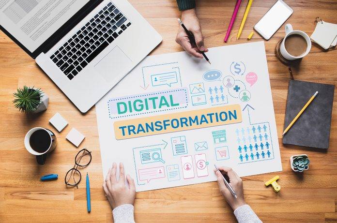 laptop and spreadsheet working on digital transformation