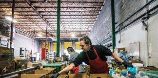 photo of man packing groceries in food warehouse