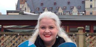 Heather Skydt holds up the UWGV Blue Heart campaign