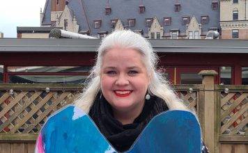 United Way Launches Blue Love Campaign in Support of Mental Health Heather Skydt holds up the UWGV Blue Heart campaign