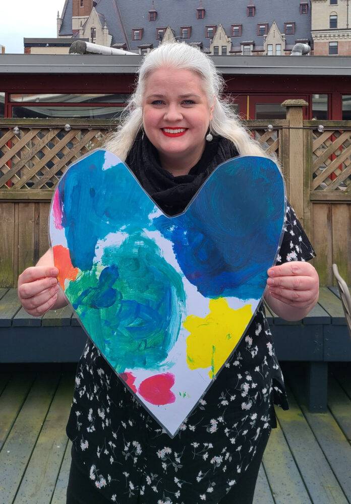 heather heart 3 cropped Heather Skydt holds up the UWGV Blue Heart campaign