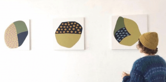 woman looking at art on a wall