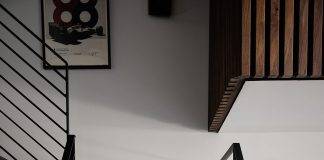Justin Tse sits on the stairs in his condo.