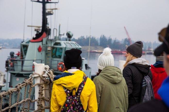 Esquimalt, British-Columbia/Canada - 10/21/2018: A group of women look out at a Canadian Navy ship at the Canadian Forces Base on Vancouver Island Esquimalt, BC V9A, Canada A By Ashley-Belle Burns