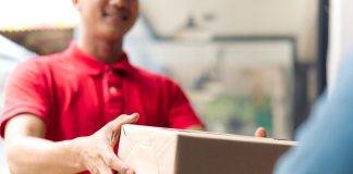 delivery man handing package to customer
