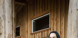Angela van den Hout in front of the longhouse at the Malahat Nation in Mill Bay. Led by Chief George Harry, the Me’ le’ xelh Mustimuhw (Malahat Nation) is a member government of the Naut’sa mawt Tribal Council, and their ancestor tongue is the Hul'qumi'num language. They reside on their traditional lands near Mill Bay, Goldstream and the Highlands and recently signed an Incremental Treaty Agreement transferring the Shawnigan Lands back to their people. Photo By: Jeffrey Bosdet.