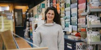 Caitlin McKenzie, President & CEO of Monk Office stands inside their newly acquired business, Island Blue Art & Framing.
