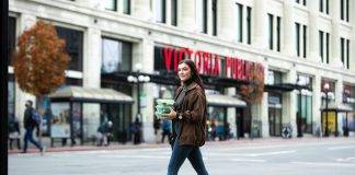 wide shot of woman walking on Douglas street in Victoria carrying an eco reusable container by Bread and Butter Collective