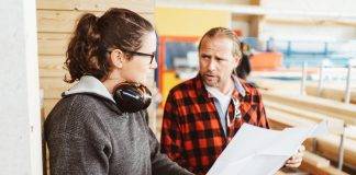 Man and woman on construction site discussing project