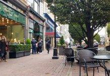 Shoppers browse stores on Government Street in downtown Victoria BC