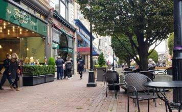 Shoppers browse stores on Government Street in downtown Victoria BC