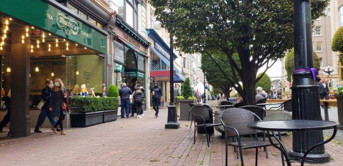 Shoppers browse stores on Government Street in downtown Victoria BC