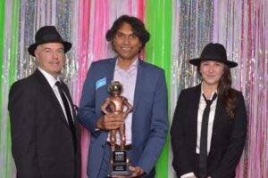 Caption: Jerome Etwaroo of Coast Capital Innovation Centre received the Colin Lennox Award as a champion of the tech ecosystem at VIATEC’s 2022 80s-themed tech community awards gala. Courtesy of Four Frames Photobooth and VIATEC)