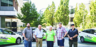 Joan Wallace, centre, is flanked by members of the team at Joan Wallace Driving School. Photo supplied.