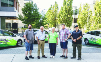Joan Wallace, centre, is flanked by members of the team at Joan Wallace Driving School. Photo supplied.