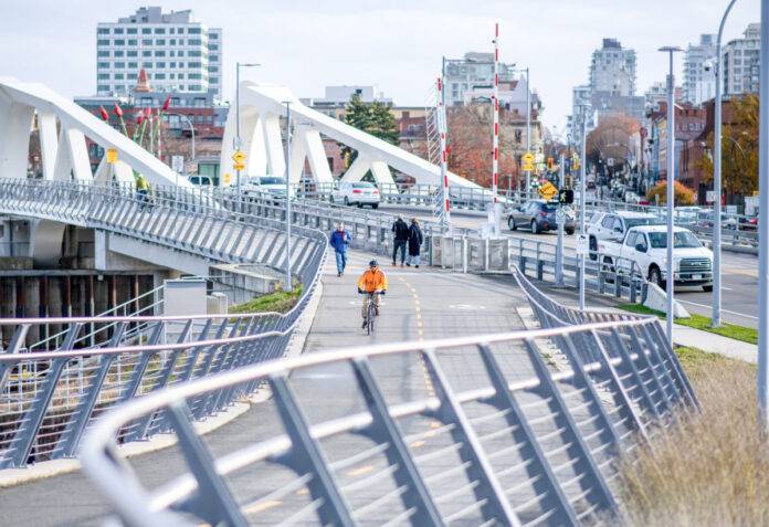 Cyclist and pedestrians on the Johnson Street Bridge. Photo: victoriarising.ca/James MacDonald.