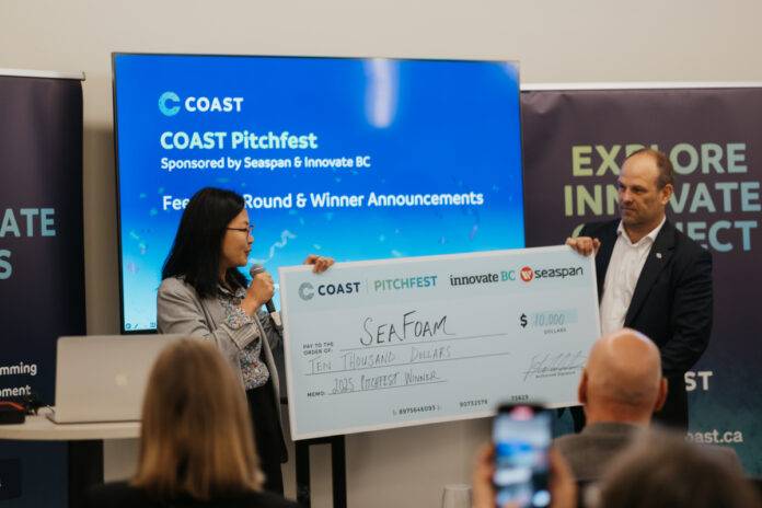 COAST-Pitch-Fest-2025-129 Jason Goldsworthy, Executive Director of COAST, presents SeaFoam co-founder Amy Yang with the $10,000 prize for COAST Pitchfest 2025. Photo credit: COAST/Megan Wilson.