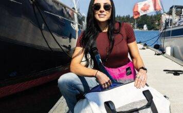 From Sails to Satchels Meaghan McDonald with Salt Legacy bags by the water.