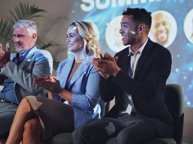 Audience clapping at an event.