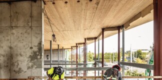 Adapting to Change Victoria construction workers assembling building framework for new firehouse