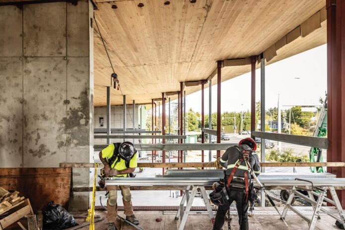Victoria construction workers assembling building framework for new firehouse