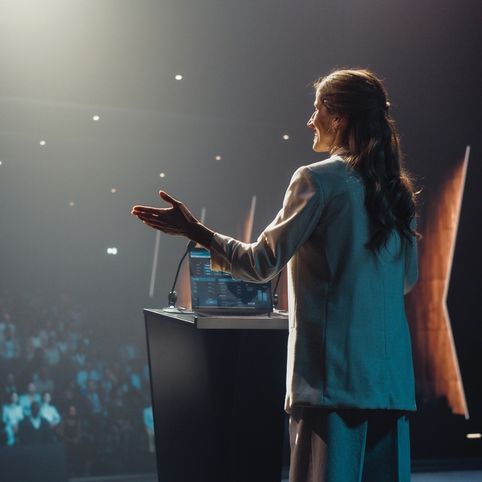 Speaker addressing a large audience.