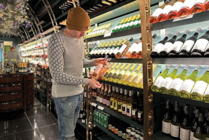 Dry January Person selecting non-alcoholic beverages from shelf