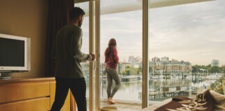 Couple enjoying a scenic hotel view of Victoria's Inner Harbour